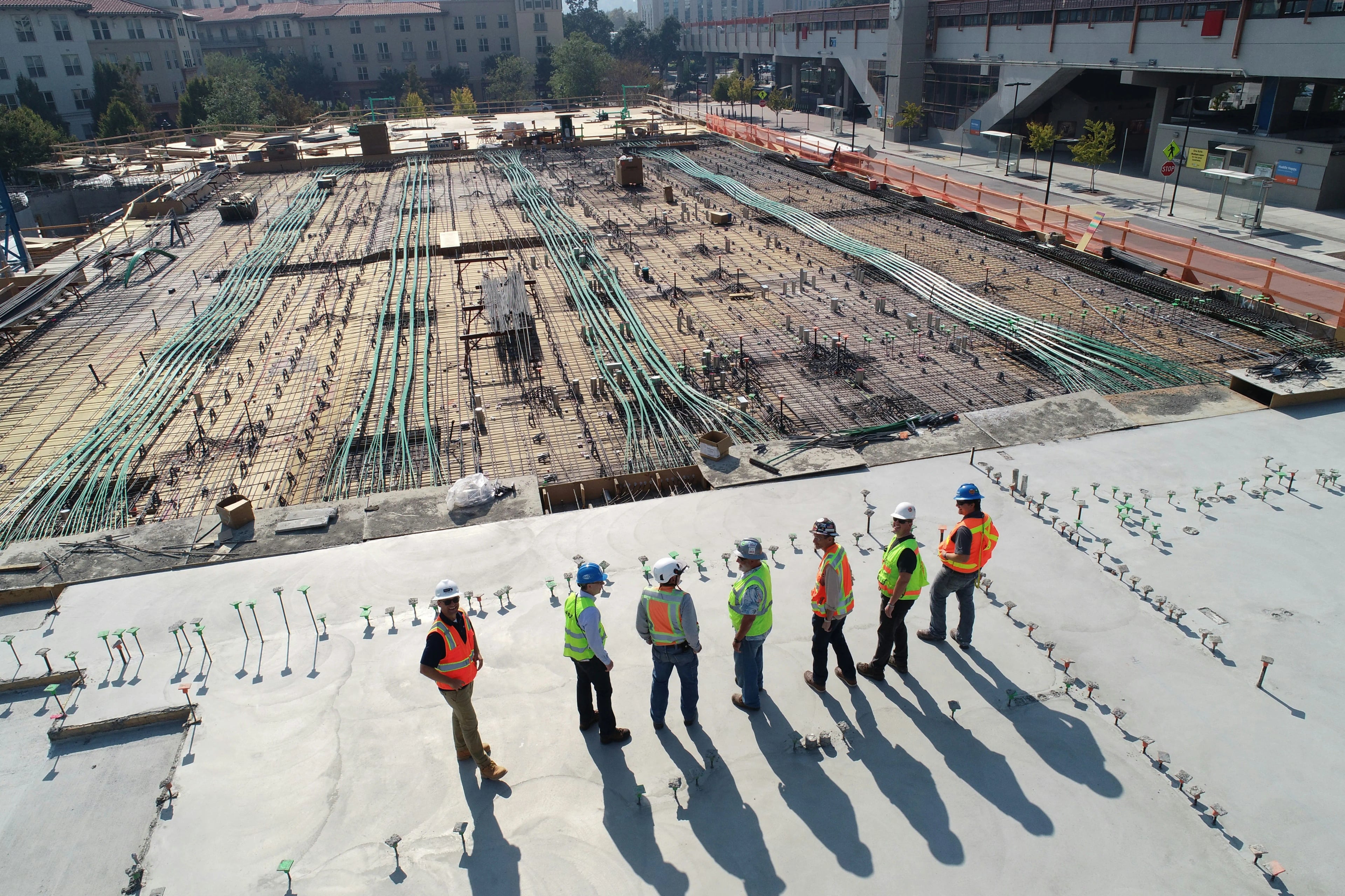 Construction supervisors reviewing work on a large commercial building site